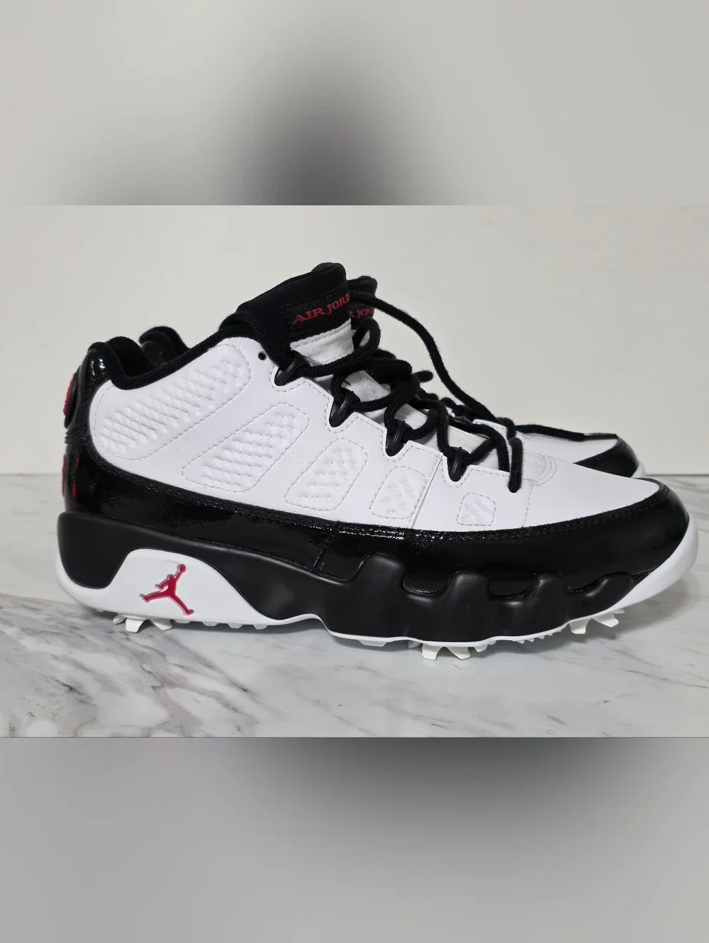 Jordan White and Black Golf Cleats with Red Logo